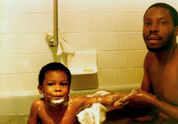 Old photograph of the perfumer, Justin Charles, as a young child in the bath with his father, brand namesake Jean Robert Charles.